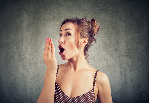 A woman with her mouth open, displaying a surprised expression, conveying shock or astonishment.