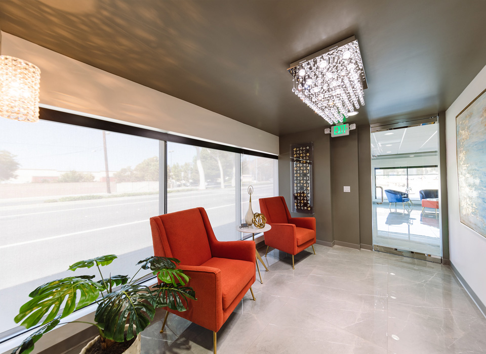 A hallway featuring two chairs and a decorative plant, creating a welcoming and serene atmosphere.