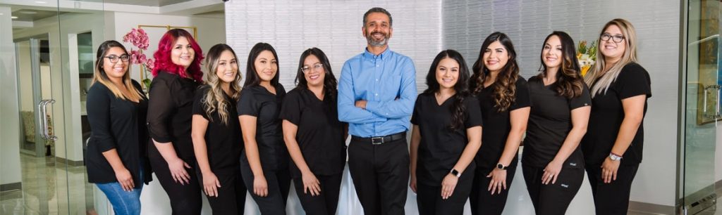 A professional dental team smiling together at Dentistry by the Sea, showcasing their commitment to patient care and teamwork.